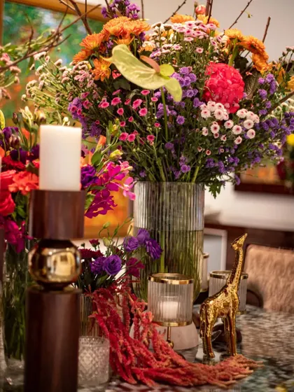 A golden giraffe figurine peeks out from among the flowers, adding a touch of whimsy to the sophisticated arrangement. These small details are what make our designs memorable.