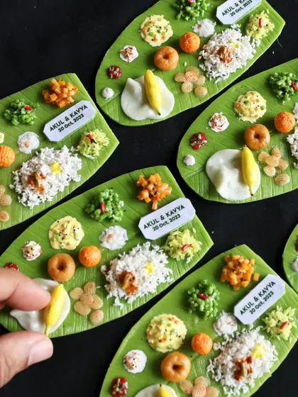 A set of custom-made South Indian meal magnets created as wedding return gifts, complete with personalized name tags.