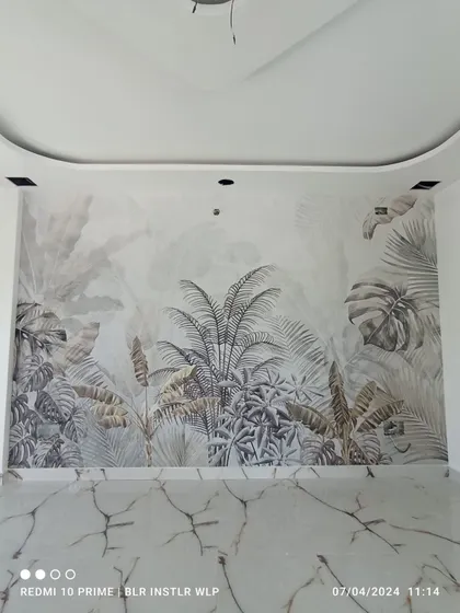 A grayscale tropical jungle mural, creating a sophisticated and modern look in this empty room.