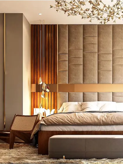 This luxurious bedroom combines rich textures for a warm and inviting feel. The padded headboard is set against a wall of wood and upholstered panels, creating a sophisticated and comfortable retreat.