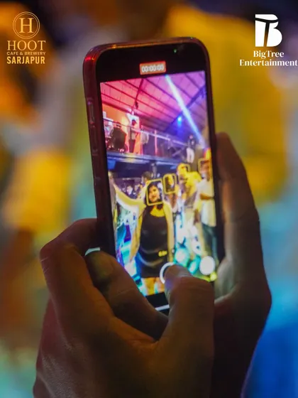 A partygoer capturing the moment on their phone, a common sight at my gigs.
