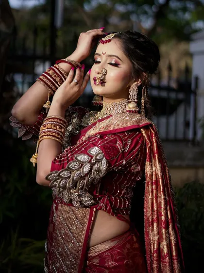 A dramatic pose highlighting the bride's eyes and the stunning details of her `Navari` saree and blouse.