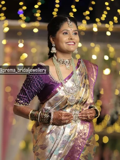 Another beautiful portrait of the client, showing her complete look. The purple saree and mint green jewellery create a lovely color combination.