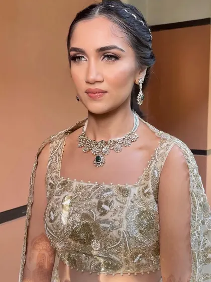 A modern braided hairstyle for a pre-wedding event. The intricate braids at the crown add a touch of elegance to the look.