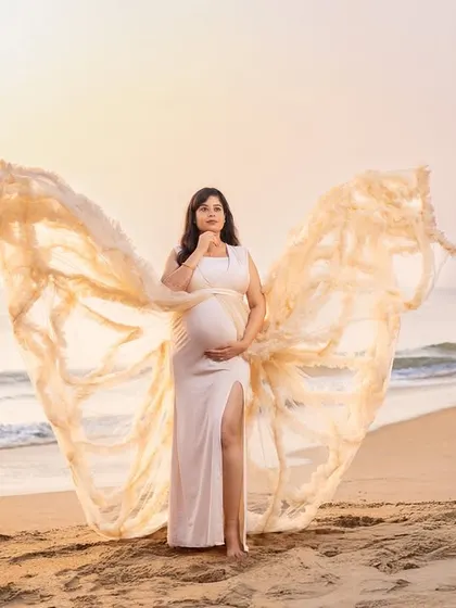 Like a scene from a dream, this butterfly gown in a soft cream color looks absolutely angelic against the sunrise. We help you choose the perfect gown to match the soft, magical light of a beach morning.