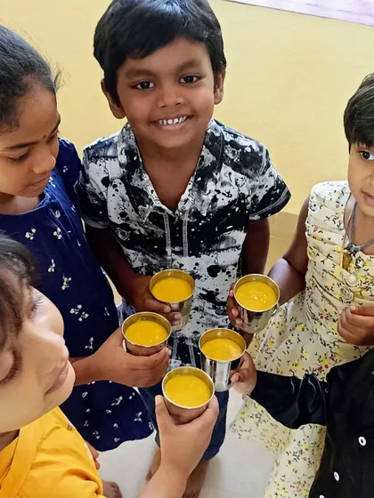 Pure happiness and satisfaction as the children enjoy the mango milkshakes they helped prepare. Sharing food they've made together is a wonderful community-building experience.