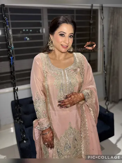 This pose shows how the hairstyle works with the full outfit and henna, creating a cohesive and stunning look.