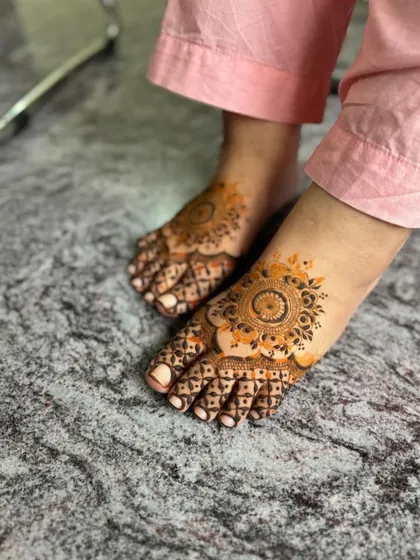 A view of both feet, showing the matching mandala designs.
