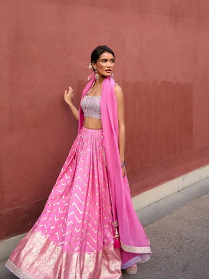 This vibrant pink lehenga from the Anam Cara collection is full of joy and movement. The gota patti work on the skirt adds a traditional touch to this modern silhouette.