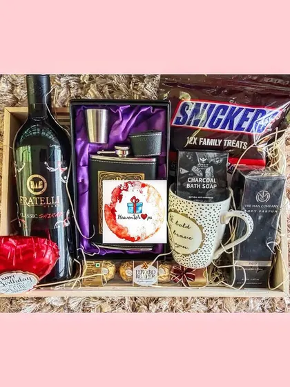 A sophisticated birthday hamper for him, combining a bottle of premium non-alcoholic wine with a stylish hip flask set, gourmet chocolates, and grooming essentials. It's the perfect blend of classic and modern.