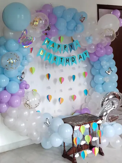 A soft and pretty birthday backdrop using pastel blue, purple, and white balloons. I added confetti balloons and butterfly cutouts to give it a whimsical feel, perfect for a child's party.