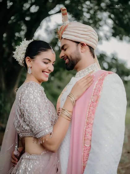 A bright, joyful smile that says it all. This candid shot captures a moment of pure happiness and affection between the newly engaged couple.