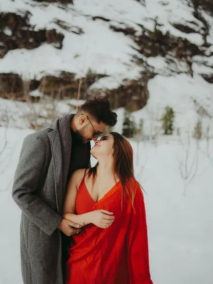 An almost-kiss moment, capturing the intimacy and romance of a pre-wedding shoot in the snow.