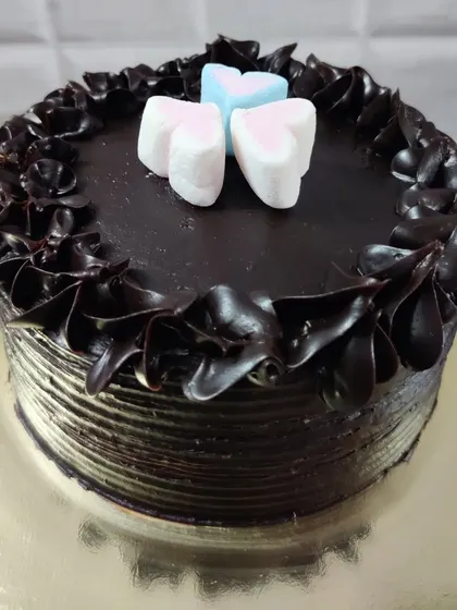 A simple chocolate cake topped with three heart-shaped marshmallows. Sometimes the simplest things are the sweetest.