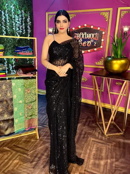 For a chic and modern look, this black sequin saree is a showstopper. It's perfect for cocktail parties, receptions, or any evening event where you want to sparkle and make a statement.