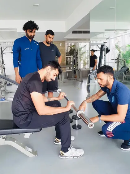 Providing one-on-one feedback on bicep curl technique. Even with simple exercises, precision matters for isolating the target muscle and preventing compensatory movements.