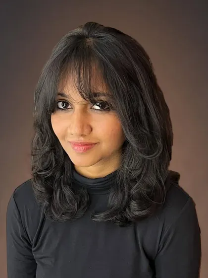 Wispy bangs and diffused face-framing layers for Pravallika.