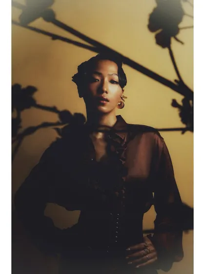 A full-length portrait from the same setup with shadow play. This shot shows how a simple background and lighting effect can create a dramatic and compelling fashion portrait.
