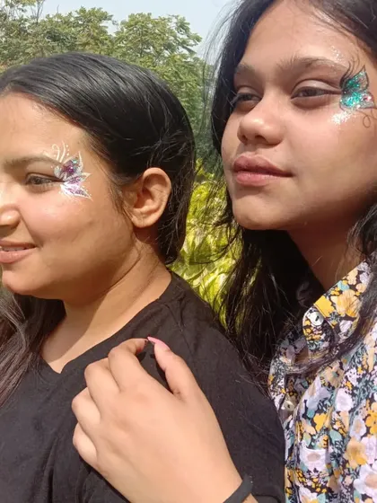 Friends who get painted together, stay together. Two different butterfly designs, one in purple and one in teal, at Amity University.