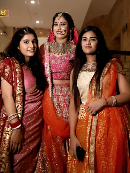A lovely group photo of the bride with her friends or family. It's all about capturing the celebration and the people who are there to support her.