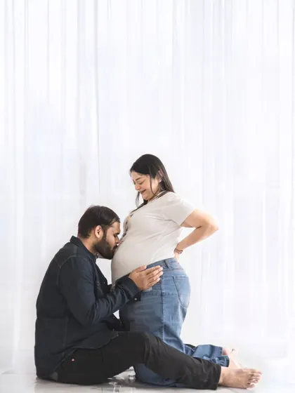 The connection between partners is a beautiful part of the pregnancy journey. We create a comfortable space for these tender, unscripted moments, like a gentle kiss to the baby bump.