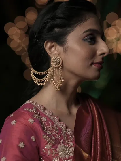 The Bahubali earring is a masterpiece of design, connecting the earring to the hair with delicate pearl chains. It’s a favorite for brides who want a look of royal elegance.
