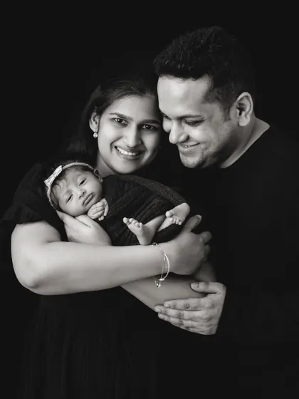 The same family portrait in black and white. This version emphasizes the emotion and connection, creating a timeless, artistic image.