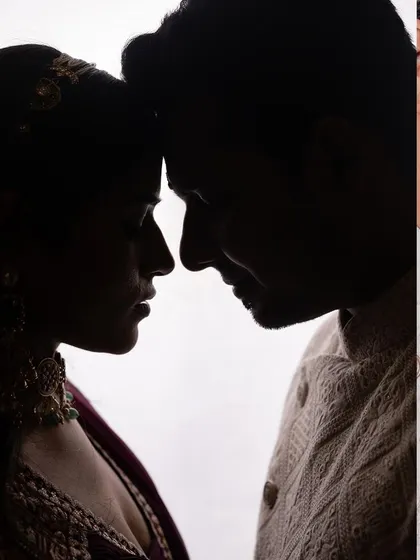 A powerful silhouette portrait of a couple on their engagement day. This artistic shot focuses on their profiles and the connection between them, creating a timeless and emotional image.