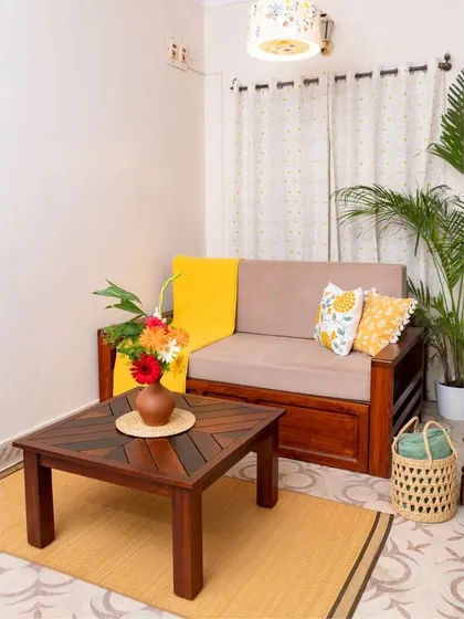 A vibrant living room scene featuring our custom sofa-bed and a unique coffee table with a patterned wood top, ready for the festive season.