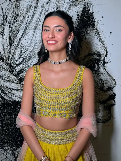 A bright and happy look for a party. The yellow lehenga is paired with shimmery eyes, a dewy base, and glossy lips.