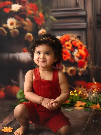 That moment you realize you're the star. Her squishy cheeks and big, beautiful, sparkling eyes are just adorable in this fall-themed toddler shoot.