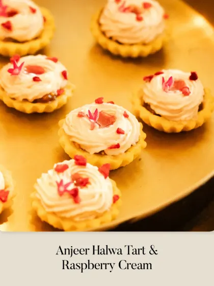 A beautiful array of Anjeer Halwa Tarts with Raspberry Cream, showcasing the delicate piping work and vibrant color contrast.