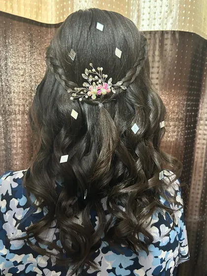 A close-up of the braided detail and floral accessory in this half-up style.