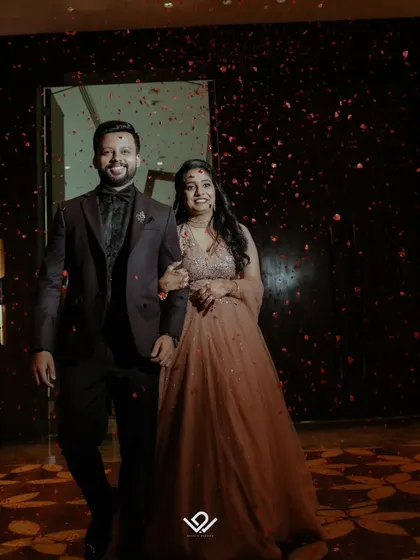 A grand entrance at an engagement party, with the couple walking through a shower of confetti.