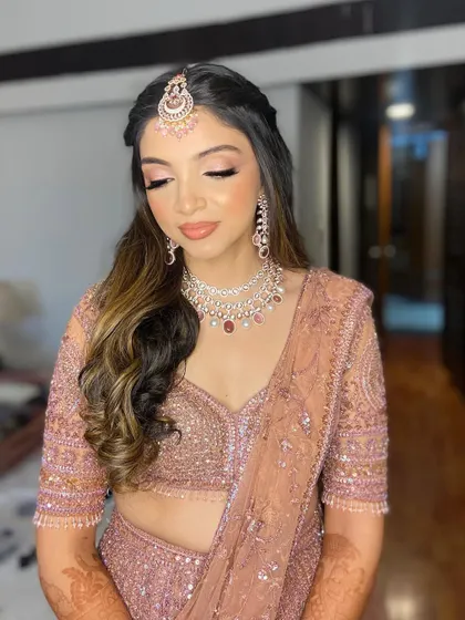 The eyes-closed shot showcases the delicate and romantic eyeshadow work, perfect for an engagement ceremony.