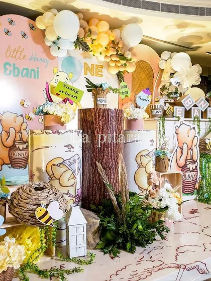 A wide view of the main stage, featuring Piglet and Pooh, with a floor decorated to look like a map of the Hundred Acre Wood.