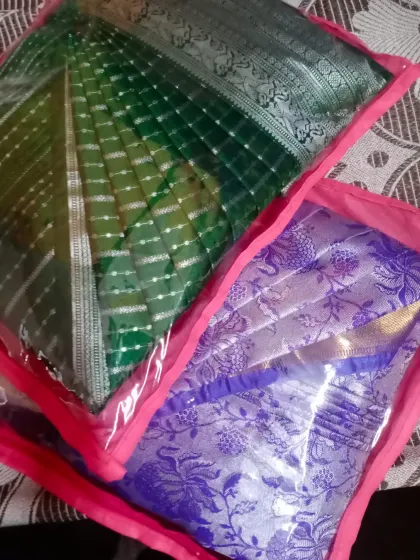 Two sarees packed in custom bags after pleating. This not only keeps them neat but also makes them perfect for gifting or travel.