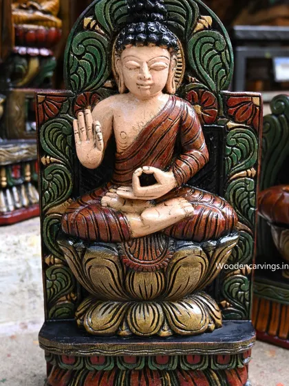 A close-up of an 18-inch seated Buddha, hand-painted with a vibrant green and red background, seated on a lotus.