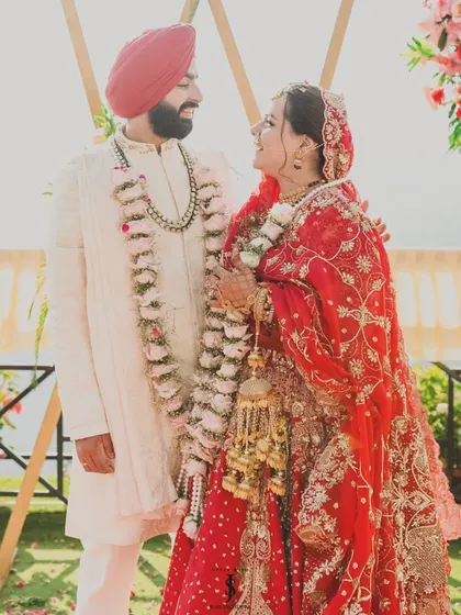 A beautiful moment from my sister's wedding. Her traditional red lehenga and his classic ivory sherwani create a timeless look for their Anand Karaj ceremony.