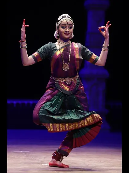 A dynamic pose capturing the Tandava, the vigorous dance of Lord Shiva. The posture conveys power, strength, and the cosmic rhythm of creation and destruction.