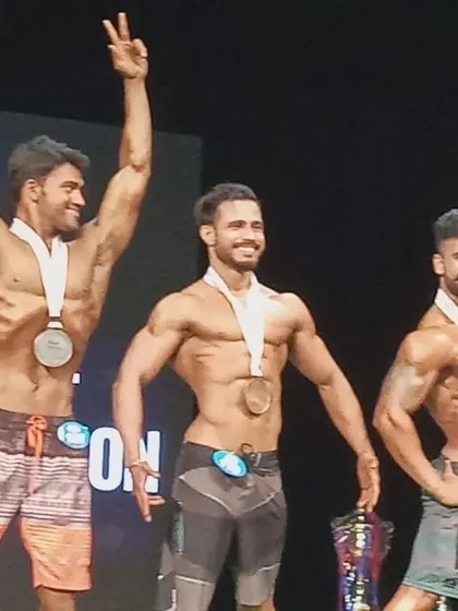 On stage at the INBA natural bodybuilding competition. After months of dedicated training and diet, my client secured a silver medal, a proud moment for both of us.