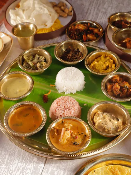 My Sadya On A Thali (SONATA) brings the full feast experience in a convenient format. It includes a curated selection of veg and non-veg dishes, from Avial and Kootu Curry to Mutton Pepper Roast, served in traditional brass bowls.