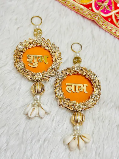 An elegant Shubh Labh set with a golden wreath design and shell tassels. This piece combines modern aesthetics with traditional blessings, perfect for a contemporary home.