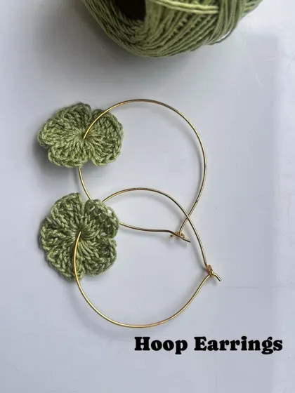 Here are the 3-in-1 floral earrings styled as hoops. The little green flower slides right onto the golden hoop.