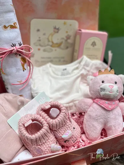 A wider view of the celestial hamper, showing how I layer items like the swaddle, clothing, and toys to create a full and luxurious gift.