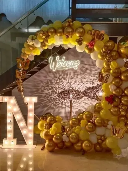 Another view of the elegant welcome party decoration. The play of light from the neon sign and marquee letters creates a beautiful shadow effect on the wall, adding to the ambiance.