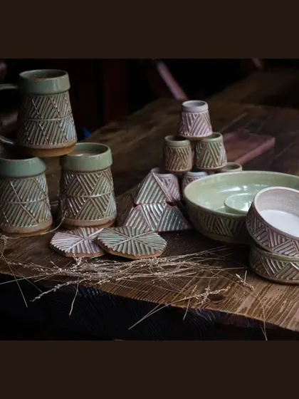 The full KHUMĀR collection, featuring beer mugs, shot glasses, bowls, and a chip and dip platter. It's everything you need to host in style.