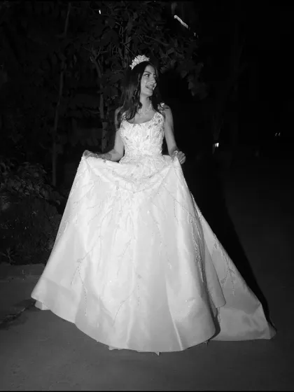 A dreamy black and white photo of the bride in a white wedding gown, captured at night for a magical, fairytale feel.