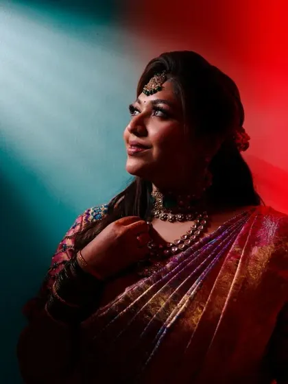 An artistic bridal portrait using dramatic red and blue lighting to create a modern and edgy look.