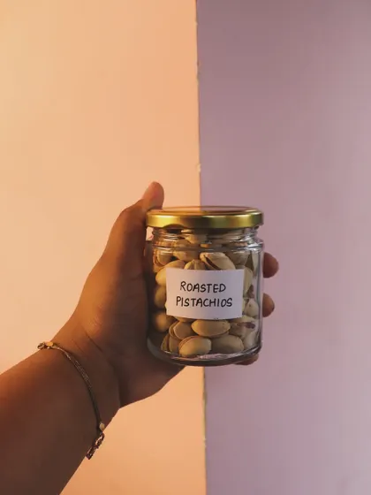 A jar of roasted pistachios, one of the savory snack options I offer in my mix-and-match hampers.